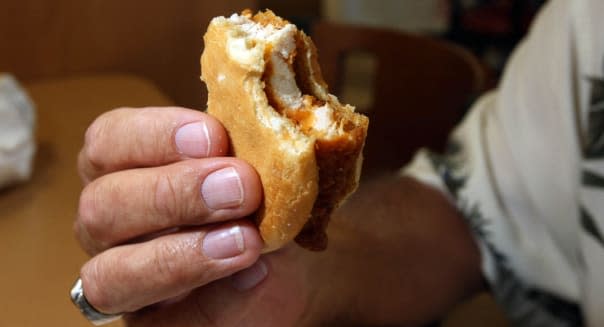 032210 (Allen Eyestone / The Palm Beach Post)  WEST PALM BEACH, FL ..  A customer taste tests the new spicy chicken sandwich fro