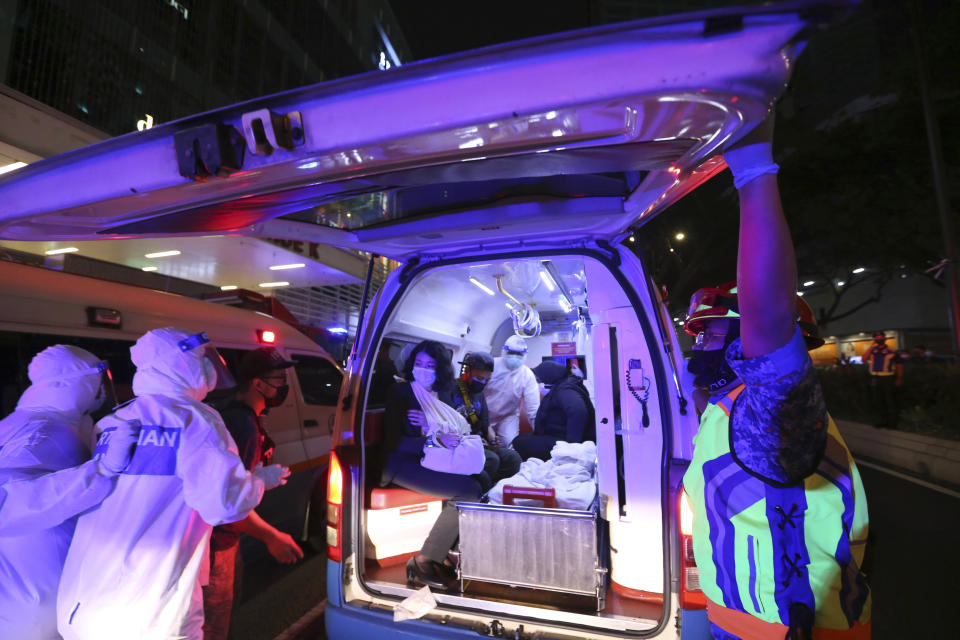 Rescue personnel help injured passengers at KLCC station after two light rail trains collided in a tunnel, injuring more than 200 people in Kuala Lumpur, Malaysia, Monday, May 24, 2021. (AP Photo)