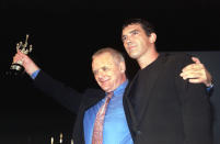 British actor Anthony Hopkins (L) holds up the trophy after receiving the "European Donostia" prize from Spanish actor Antonio Banderas (R) during a ceremony at the San Sebastian Film Festival September 19. Banderas and Hopkins co-star in the new film "The mask of Zorro", which was showed after the prize presentation.