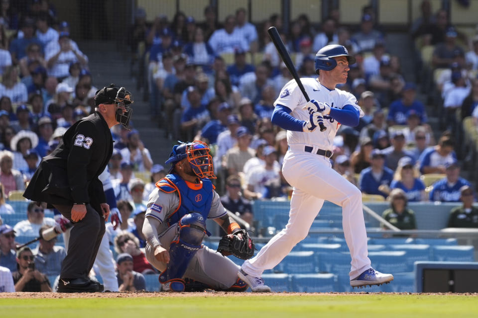 Los Angeles Dodgers' Freddie Freeman singles during the sixth inning of a baseball game against the New York Mets in Los Angeles, Saturday, April 20, 2024. Andy Pages and Gavin Lux scored. (AP Photo/Ashley Landis)