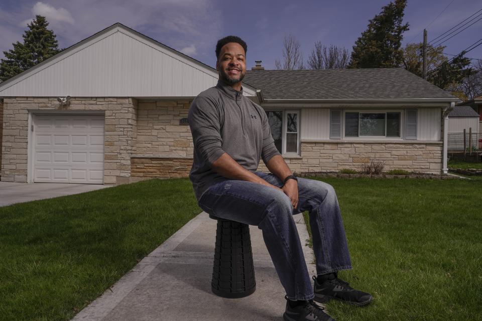 Chris Alexander poses for a picture outside his Wauwatosa, Wis., home on April 23, 2021. (AP Photo/Morry Gash)