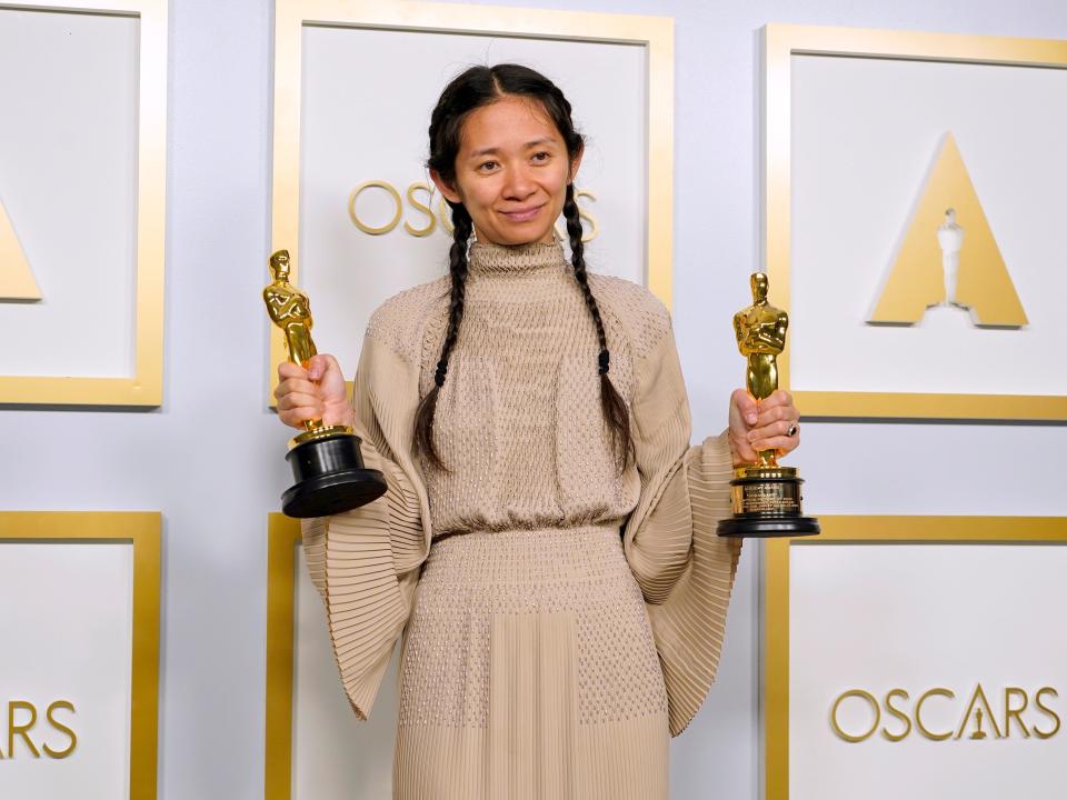 Chloé Zhao holds her awards for best picture and best director at the 93rd Academy Awards in 2021.