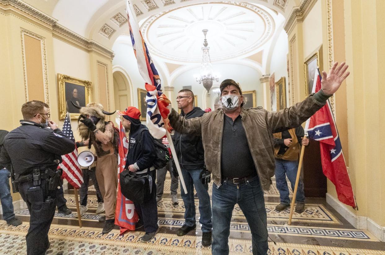 <span class="caption">Rioters carrying white supremacist symbols were inside the Capitol on Jan. 6.</span> <span class="attribution"><a class="link " href="https://newsroom.ap.org/detail/CapitolBreachRacistSymbols/11d6db73a14346f3879ec4aeebadc599/photo" rel="nofollow noopener" target="_blank" data-ylk="slk:AP Photo/Manuel Balce Ceneta;elm:context_link;itc:0;sec:content-canvas">AP Photo/Manuel Balce Ceneta</a></span>