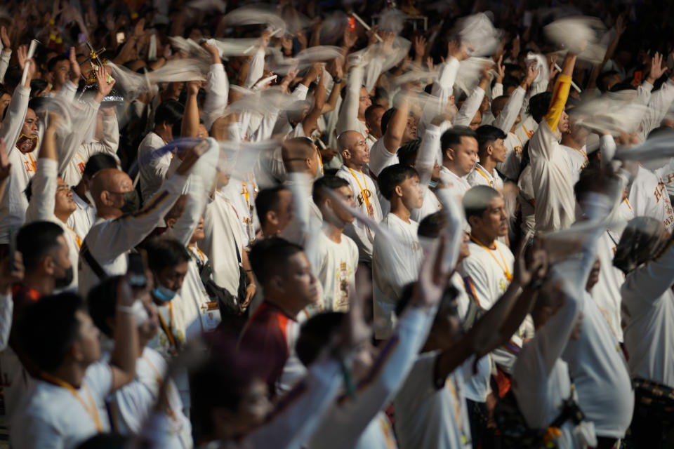 Devotees wave their towels as they join in the "Walk of Faith" procession as part of celebrations for the feast day of the Black Nazarene, a centuries-old charred statue of Jesus Christ, on Sunday, Jan. 8, 2023, in Manila, Philippines. The Black Nazarene draws massive numbers of largely poor devotees who pray for the sick and a better life in this predominantly Roman Catholic nation. (AP Photo/Aaron Favila)