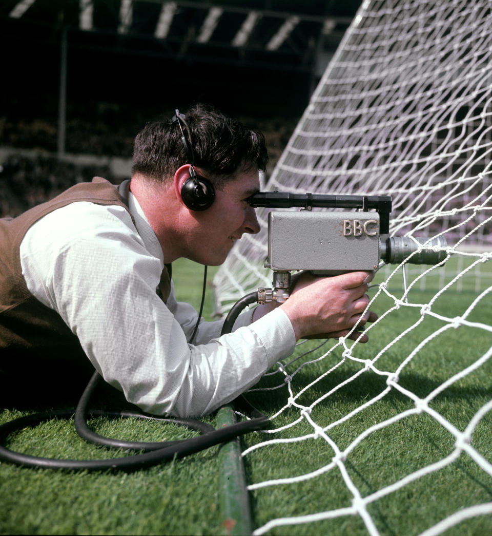 A BBC camera man films through the goal