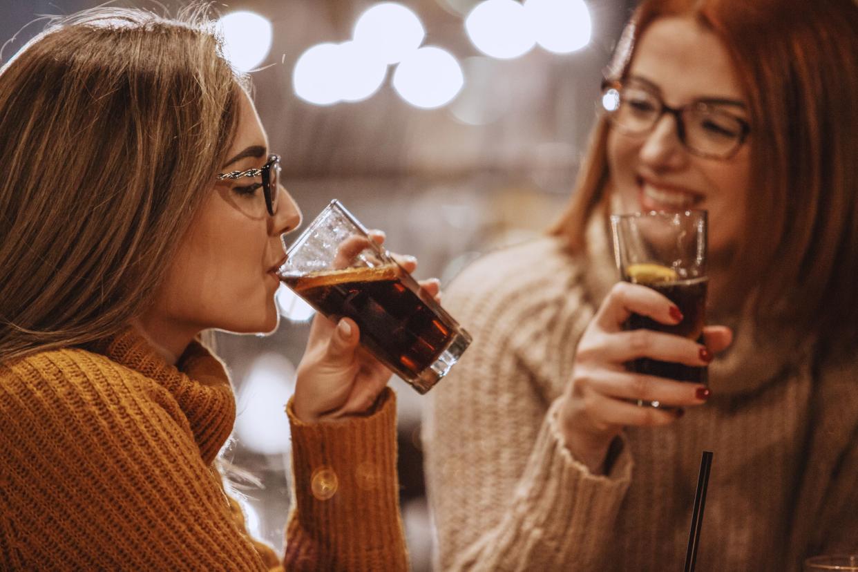 two women drinking soda at restaurant