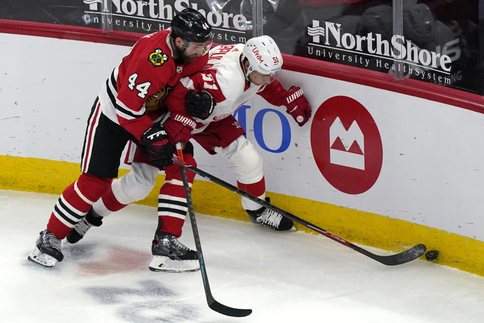 Chicago Blackhawks defenseman Calvin de Haan, left, and Detroit Red Wings center Valtteri Filppula vie for the puck during the third period of an NHL hockey game in Chicago, Saturday, Feb. 27, 2021. (AP Photo/Nam Y. Huh)