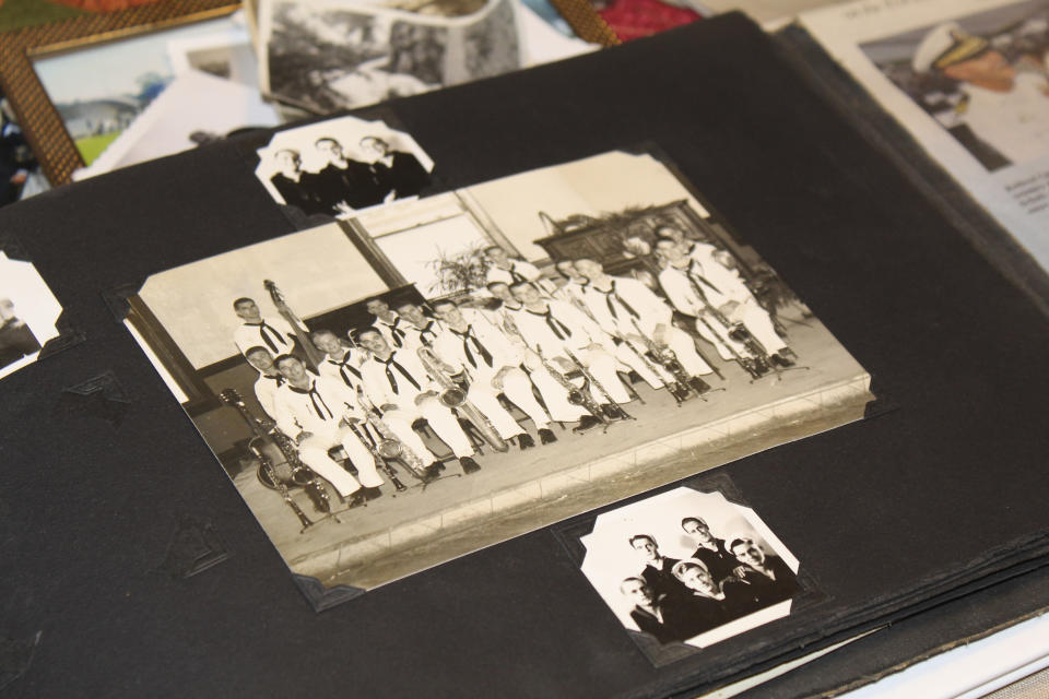 A photo album in the home of Pearl Harbor survivor Ira "Ike" Schab in Beaverton, Ore. on Monday, Nov. 20, 2023, shows an old group photo of the U.S. Navy Band. Schab, now 103, played tuba in the band and remained close with his bandmates for decades after the war. Schab plans to return to Pearl Harbor for the 82nd anniversary of the attack to remember the more than 2,300 servicemen killed. (AP Photo/Claire Rush)