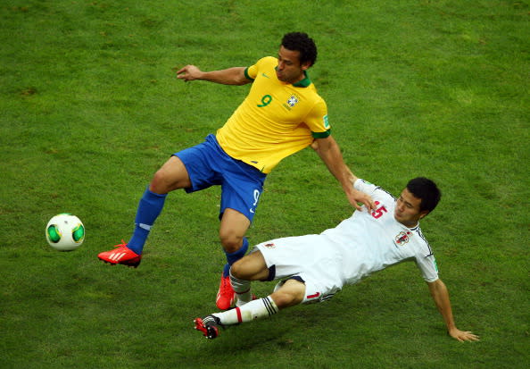 BRASILIA, BRAZIL - JUNE 15: Fred of Brazil is tackled by Yasuyuki Konno of Japan during the FIFA Confederations Cup Brazil 2013 Group A match between Brazil and Japan at National Stadium on June 15, 2013 in Brasilia, Brazil. (Photo by Clive Mason/Getty Images)