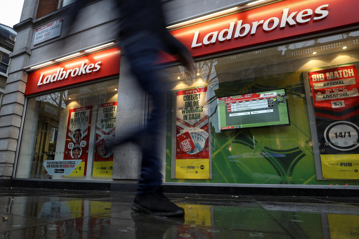 Entain  A pedestrian walks past a branch of Ladbrokes in London, Britain December 22, 2017. REUTERS/Simon Dawson