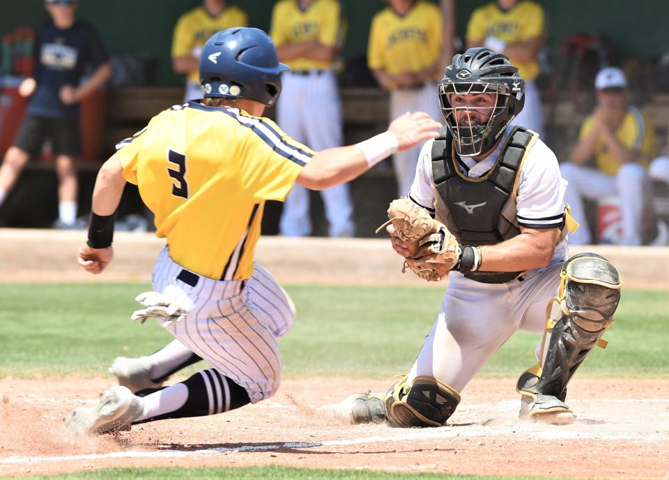 Snyder catcher Bryce Ford, right, waits to tag out Eli Hiitola at home plate in the fifth inning. Hiitola was trying to score from third on K.B. Bowman's one-out single to left. The Yellow Jackets beat Snyder 12-8 on May 28 at Hardin-Simmons' Hunter Field to sweep the Region I-4A semifinal series.