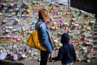 <p>A woman and child gaze at a wall filled with messages of condolence on the south end of London Bridge following the June 3 2017 attacks in London, England. </p>