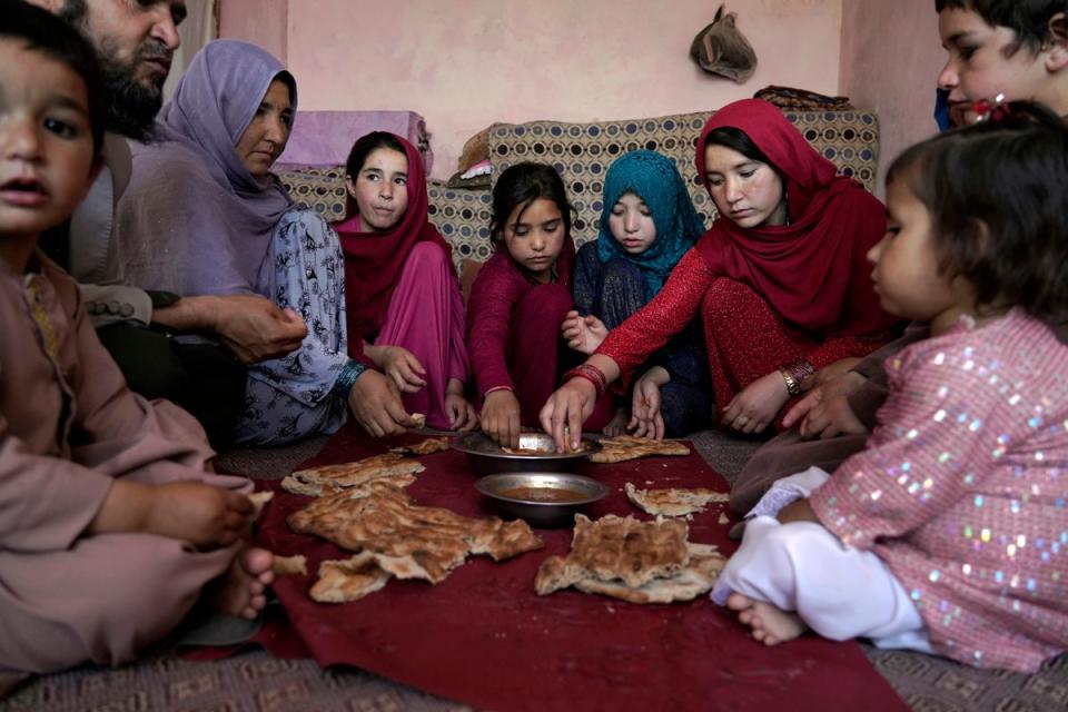 An Afghan family eat lunch in their home in one of Kabul's poor neighbourhoods in Kabul, Afghanistan (Copyright 2022 The Associated Press. All rights reserved.)
