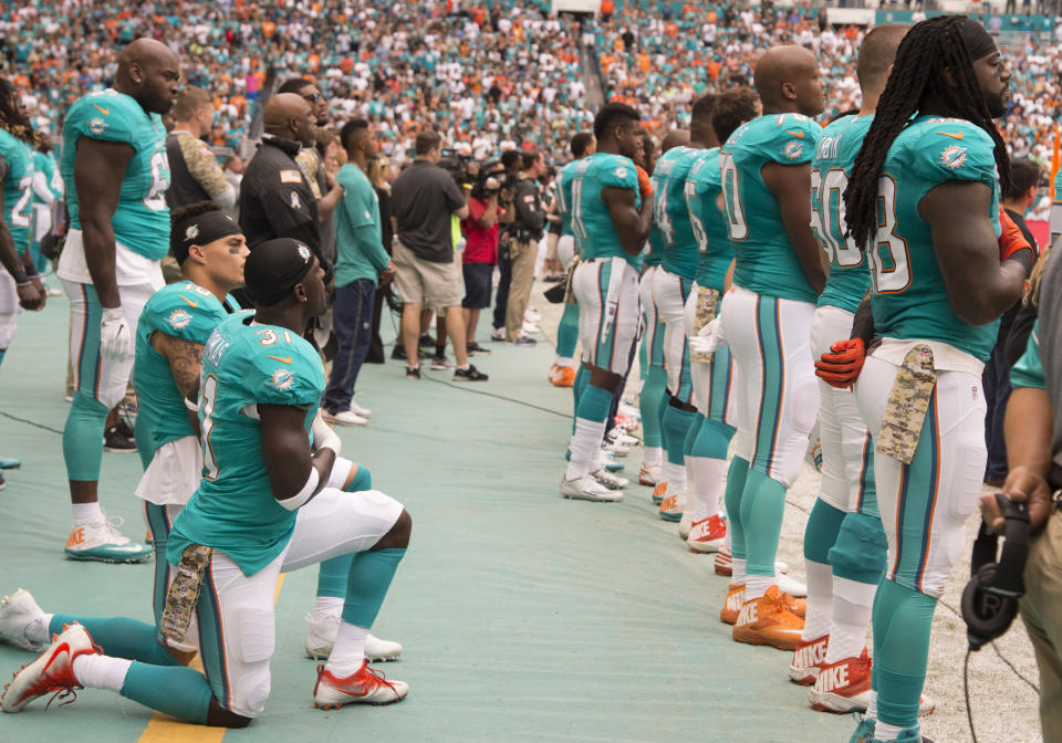 Miami Dolphins Safety Michael Thomas (31) and Miami Dolphins Wide Receiver Kenny Stills (10) kneel in protest during signing of the National Anthem during the NFL football game between the New York Jets and the Miami Dolphins on November 6, 2016, at the Hard Rock Stadium in Miami Gardens, FL. (Photo by Doug Murray/Icon Sportswire via Getty Images)