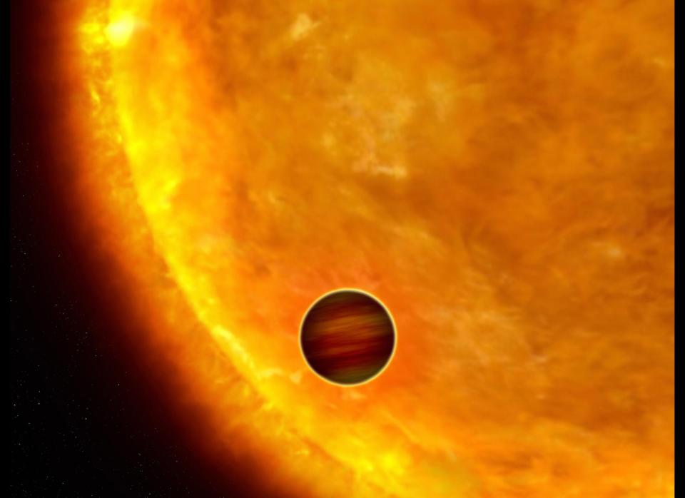 Picture released on Oct. 4, 2006, by the European Space Agency shows an artist's impression of a Jupiter-sized planet passing in front of its parent star. Such events are called transits. When the planet transits the star, the star's apparent brightness drops by a few percent for a short period. Through this technique, astronomers can use the Hubble Space Telescope to search for planets across the galaxy by measuring periodic changes in a star's luminosity.&nbsp;