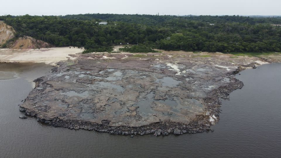 The rocky point is where two rivers - the Rio Negro and Solimões - meet. - Suamy Beydoun/Reuters