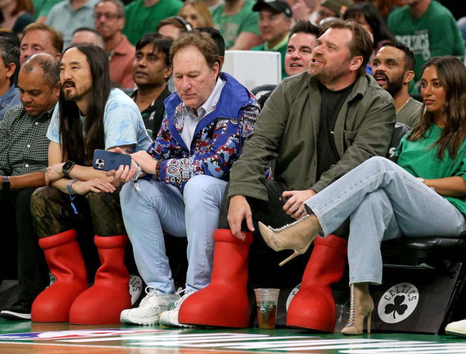 Men wearing big red boots at an event