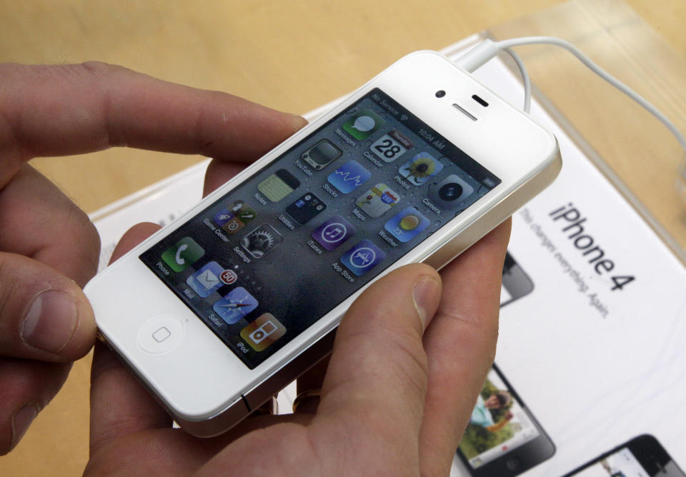 FILE - In this April 28, 2011 photo, a customer holds an iPhone at the Apple store on New York's Upper West Side. Apple Inc., the world’s most valuable company, on Tuesday, April 24, 2012 trumped skeptics once again by reporting blow-out iPhone sales. Apple says it sold 35 million iPhones in the quarter, almost twice as many as it sold a year ago and above analyst expectations. (AP Photo/Richard Drew)