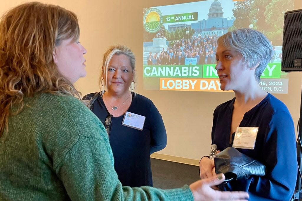 Amy Moore, (right) director of the Missouri Division of Cannabis Regulation, talks with attendees at the National Cannabis Industry Association’s summit on March 28, 2024 in St. Louis.