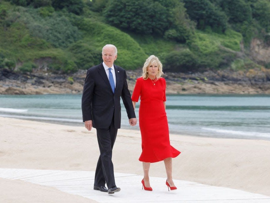 Jill and Joe Biden walk on the beach in the UK