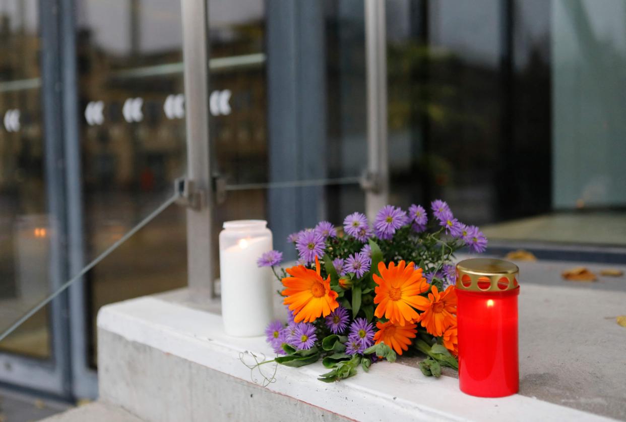 Flowers and candles are seen at the doors of the Uppsala Concert and Congress Hall on Nov. 3, 2021 in Uppsala, Sweden. Swedish pop sensation ABBA announced Nov. 3 they were holding promotions for their upcoming show for 24 hours, after two died in a dramatic fall at a tribute concert in Sweden.