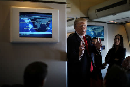 U.S. President Donald Trump talks to journalists members of the travel pool on board the Air Force One during his trip to Palm Beach, Florida while flying over South Carolina, U.S., February 3, 2017. REUTERS/Carlos Barria