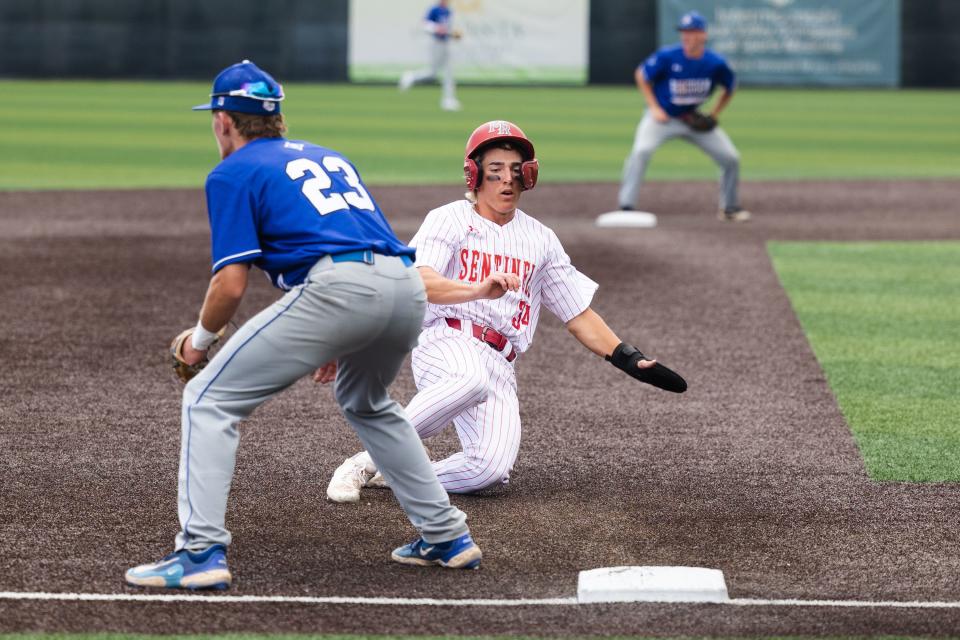 Mountain Ridge’s Remington Edwards slides into third base during 6A baseball state tournament action against Bingham at UCCU Ballpark in Orem on Monday, May 22, 2023. | Ryan Sun, Deseret News