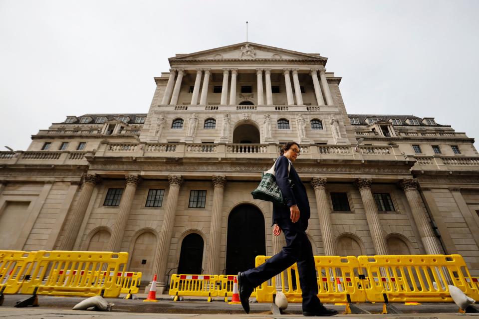 A pedestrian walks past the Bank of England in London on June 17, 2020. - The Bank of England, confronted by Britain's collapsing coronavirus-ravaged economy, will on June 18 reveal the outcome of its latest monetary policy meeting with analysts predicting more stimulus. The British central bank has been at the forefront of economic fire-fighting over this year's deadly COVID-19 emergency -- and could expand its quantitative easing (QE) stimulus in an attempt to kickstart growth. (Photo by Tolga Akmen / AFP) (Photo by TOLGA AKMEN/AFP via Getty Images)