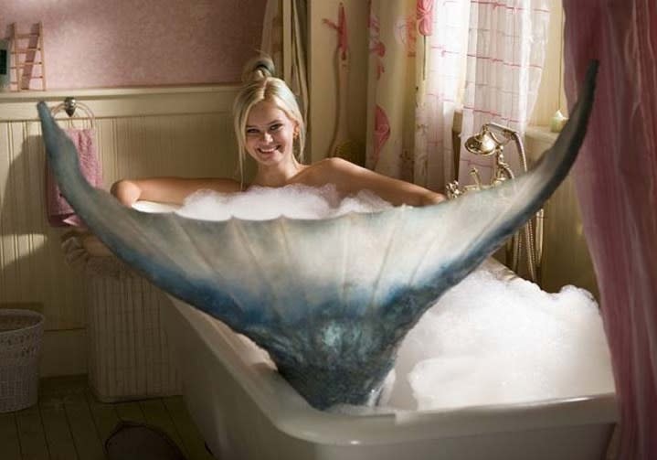 A mermaid sits in a bathtub in Aquamarine.