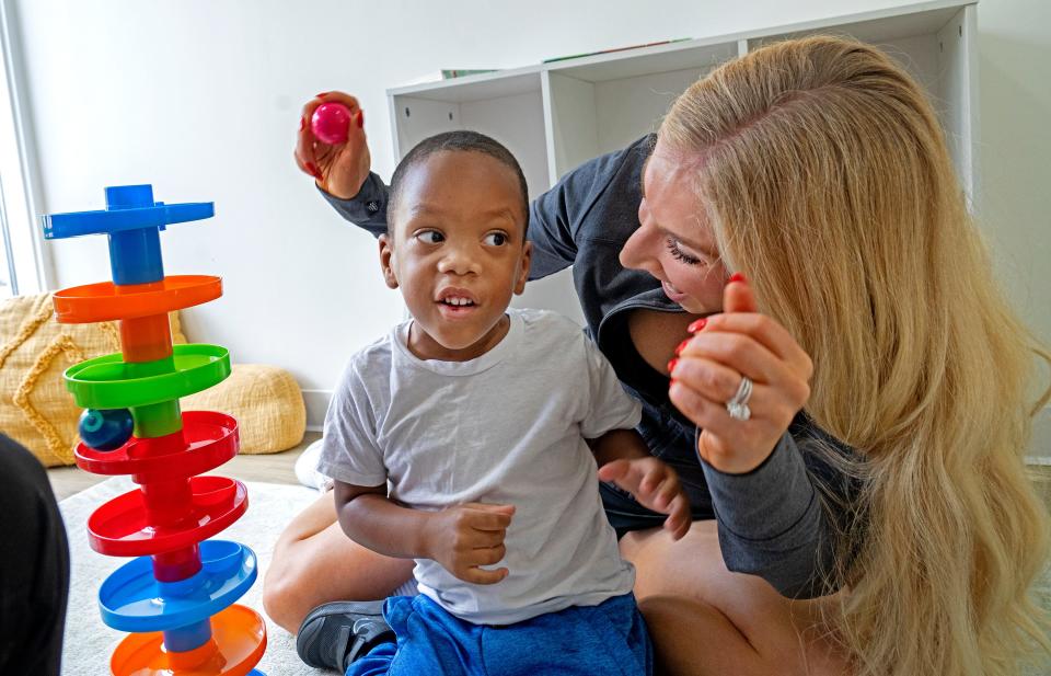 Shine Pediatric Therapy Director Courtney Hodge, right, helps Rain Parker play during his therapy session with Registered Behavior Technician Kyshau Lee, Monday, Aug. 21, 2023 at Shine Pediatric Therapy. He has benefited from the ABA, applied behavior analysis, therapy that he has received at the center to help him navigate life with autism.