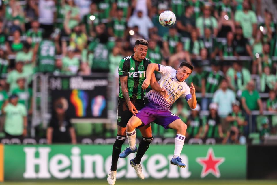 Austin FC defender Julio Cascante, left, and Orlando City SC midfielder Mauricio Pereyra jump for a ball during the teams' 2-2 draw at Q2 Stadium on Sunday.