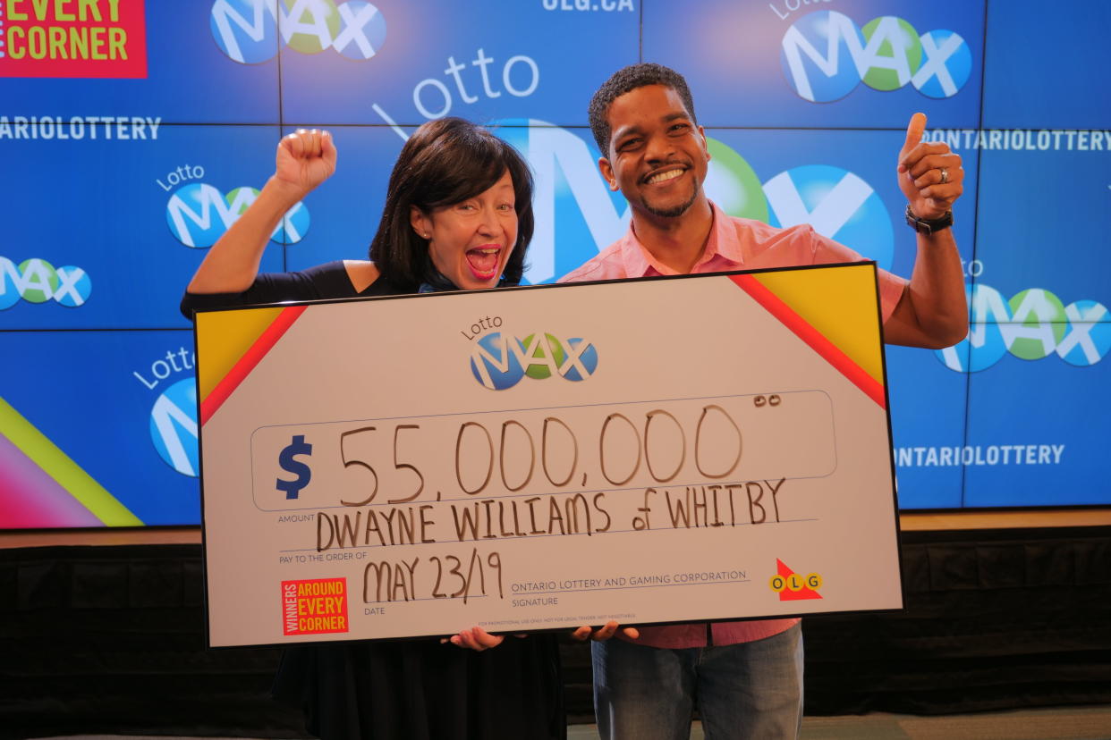 OLG’s VP Channel Management, Debora Hume, celebrates a $55 million win with Dwayne Williams from Whitby. OLG