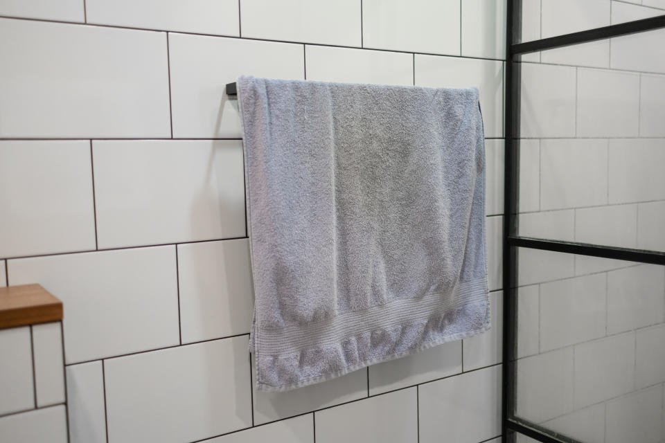 A dirty towel hanging on a rack