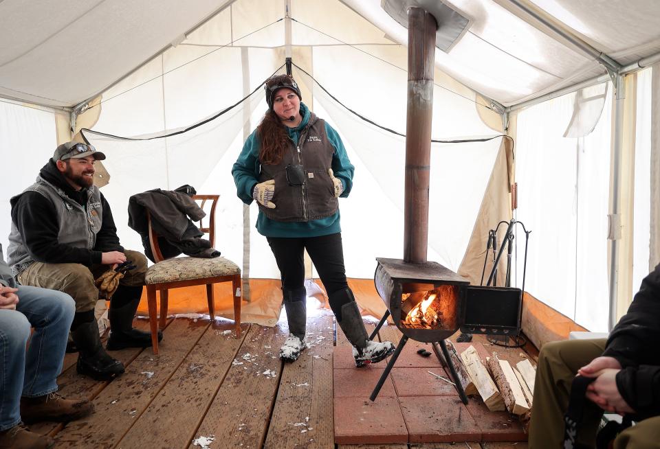 Luna Lobos Dog Sledding owner Fernando Ramirez listens as Luna Lobos Dog Sledding owner Dana Ramirez tells dog stories to their clients at Rancho Luna Lobos in Peoa, Utah, on Thursday, Jan. 11, 2024. | Kristin Murphy, Deseret News