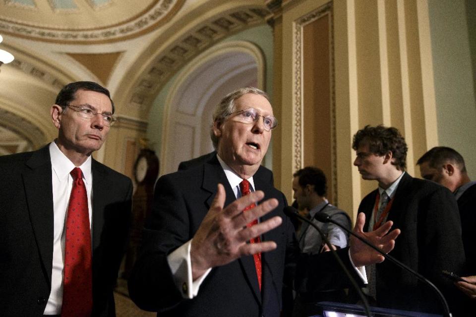 FILE - This March 5, 2014 file photo shows Senate Minority Leader Mitch McConnell of Ky., accompanied by Sen. John Barrasso, R-Wyo., speaking to reporters on Capitol Hill in Washington. The South, where President Barack Obama and his party have struggled for years, will be Democrats’ toughest battleground in the 2014 fight for control of the Senate. A trio of incumbents must face the consequences of having voted for Obama’s signature health care law, but first Republicans must settle primaries in several states, including a challenge to Minority Leader Mitch McConnell. (AP Photo/J. Scott Applewhite, File)