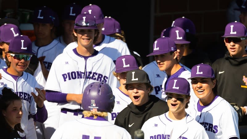 Lehi players celebrate teammate Tanner Heaps after he scores a run during a high school baseball game against Skyridge at Lehi High School in Lehi on Friday, May 3, 2024.