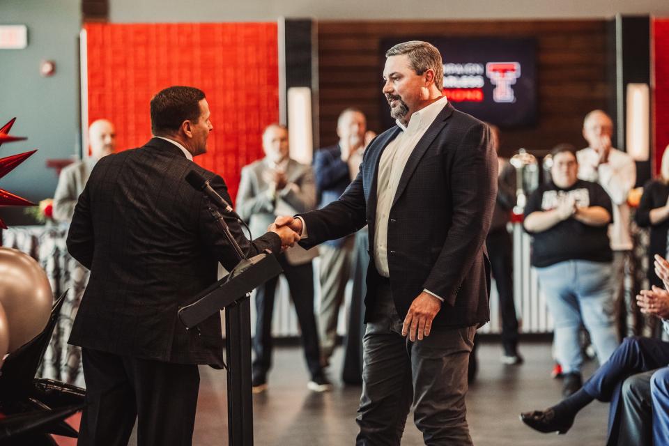 Texas Tech athletics director Kirby Hocutt, left, introduces donor Cody Campbell, right, during a press conference Thursday in Jones AT&T Stadium's north end zone club area. Campbell is making a $25 million donation to help fund a south end zone stadium building.