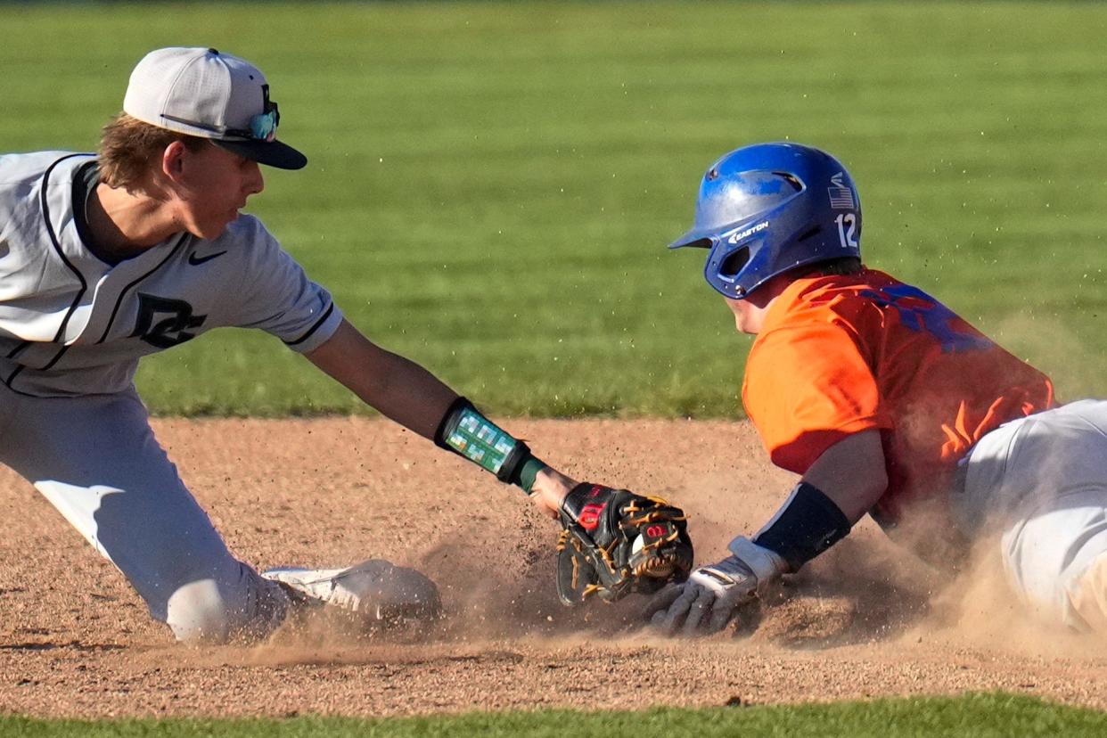 Olentangy Orange's James Wimsatt beats the tag of Dublin Coffman's Carson Wilcox during a game last season.