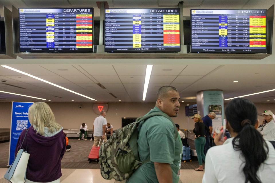 James Rodriguez talks with his wife, Diana, after their flight to Cancun was canceled at the Fort Lauderdale-Hollywood International Airport due to heavy downpours across South Florida on Wednesday, June 12, 2024, in Fort Lauderdale, Fla. (Matias J. Ocner/Miami Herald via AP)