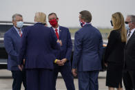 Rep. Doug Collins, R-Ga., in red face mask, talks with President Donald as he arrives at Hartsfield-Jackson International Airport, Wednesday, July 15, 2020, in Atlanta. Sen. Kelly Loeffler, R-Ga., second from right, and Sen. David Perdue, R-Ga., third from right, listen. (AP Photo/Evan Vucci)