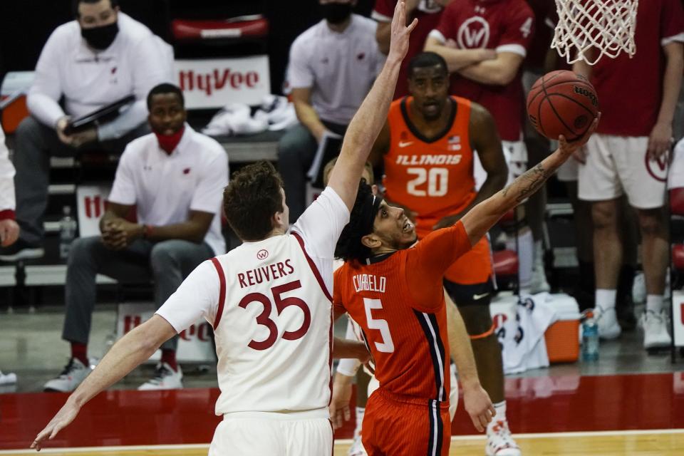 Illinois's Andre Curbelo drives past Wisconsin's Nate Reuvers during the first half of an NCAA college basketball game Saturday, Feb. 27, 2021, in Madison, Wis. (AP Photo/Morry Gash)