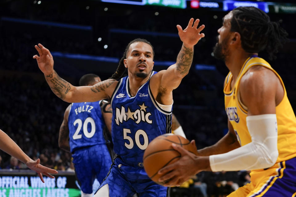 Orlando Magic guard Cole Anthony, left, defends against Los Angeles Lakers guard Gabe Vincent during the first half of an NBA basketball game, Monday, Oct. 30, 2023, in Los Angeles. (AP Photo/Ryan Sun)