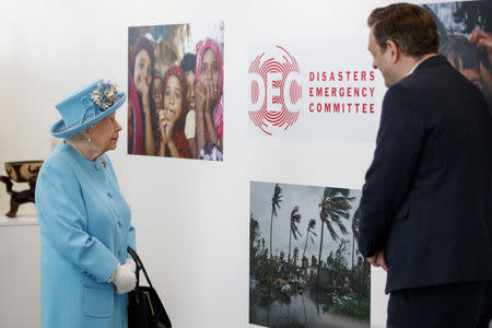 Britain's Queen Elizabeth meets an employee involved in the community investment programmes during her visit to the headquarters of British Airways, as British Airways mark their centenary year, in Heathrow, west London, Britain May 23, 2019. Tolga Akmen/Pool via REUTERS