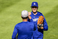 Los Angeles Dodgers' Shohei Ohtani reacts with his catcher after throwing before a baseball game against the Washington Nationals at Nationals Park, Tuesday, April 23, 2024, in Washington. (AP Photo/Alex Brandon)