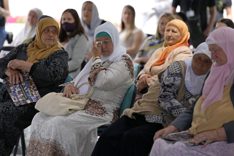 Women from Srebrenica wait to watch a live broadcast from the Yugoslav War Crimes Tribunal in The Hague and learn the verdict for Bosnian Serb military chief Ratko Mladic, at the memorial cemetery in Potocari near Srebrenica, eastern Bosnia, Tuesday, June 8, 2021. The United Nations court delivers its verdict in the appeal by former Bosnian Serb military chief Ratko Mladic against his convictions for genocide and other crimes and his life sentence for masterminding atrocities throughout the Bosnian war.(AP Photo/Darko Bandic)