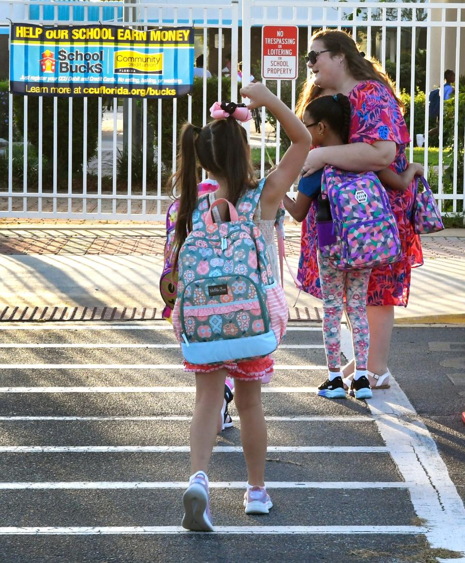 Jessica Speiser, literacy coach, greets students at the crosswalk.at Discovery Elementary in Palm Bay Thursday as Brevard County Public Schools kicks off the 2023-2024 school year.