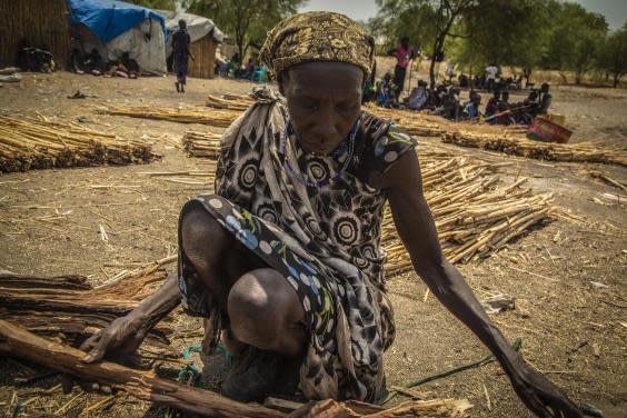 A woman sells firewood in Pibor market, South Sudan. Women risk being assaulted gathering wood (Bel Trew)