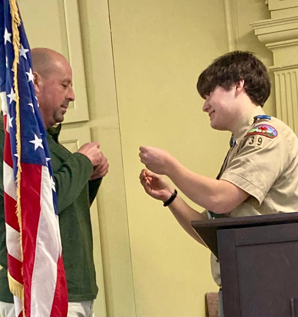 John Bennet honors Eagle Scout Al Rose with a Mentor pin.