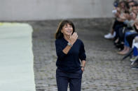 Designer Veronique Nichanian accepts applause at the end of the Hermes men's Spring Summer 2023 collection presented in Paris, France, Saturday, June 25, 2022. (AP Photo/Francois Mori)