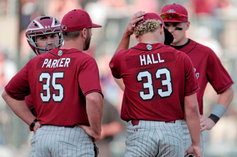 South Carolina discusses the game at the pitchers mound during the game against Clemson on Saturday, March 5, 2022.